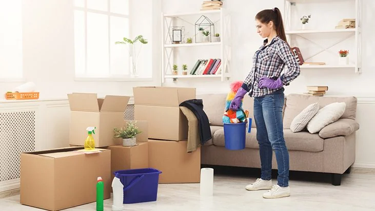 Cleaning a living room surrounded by moving boxes